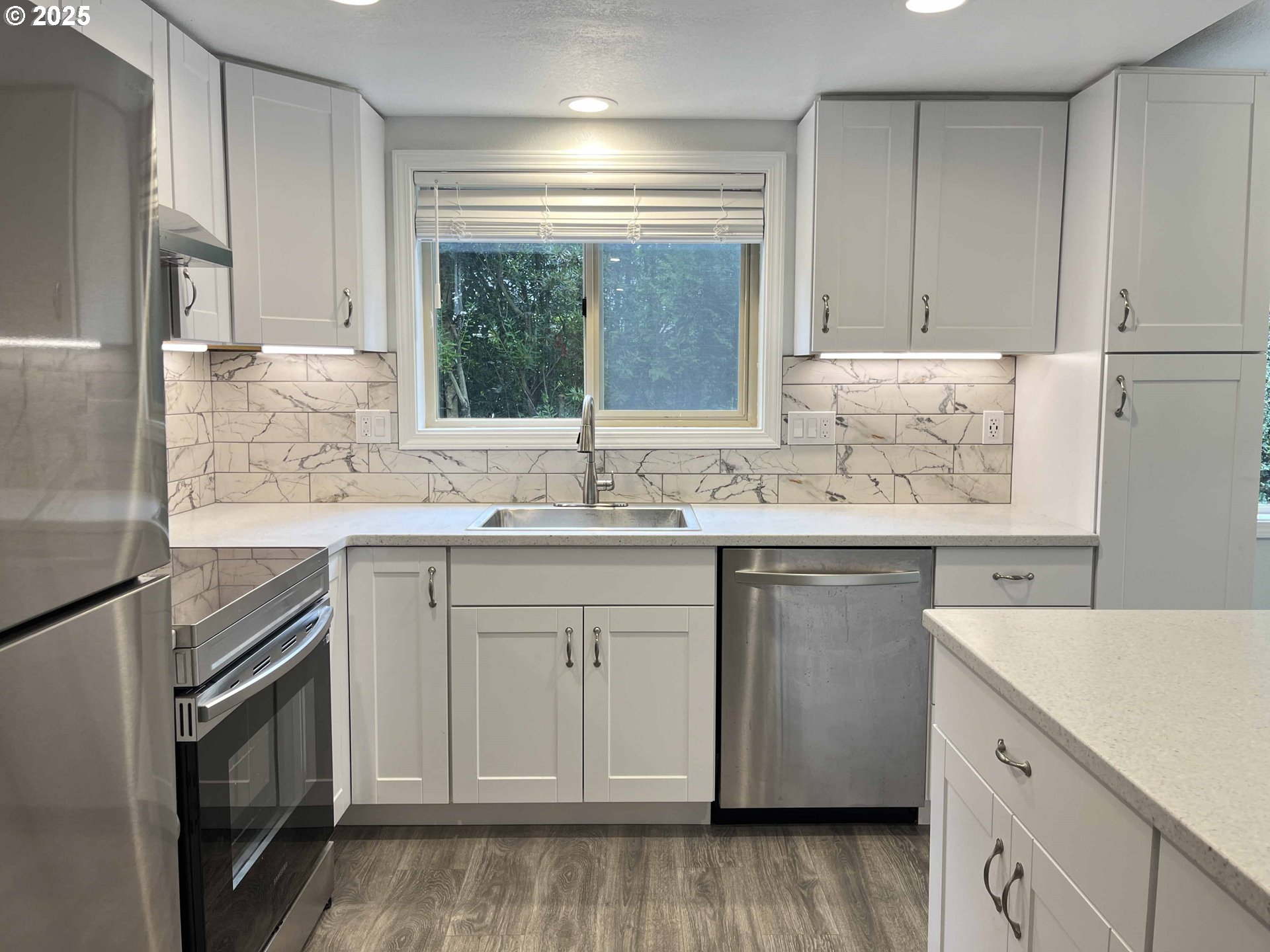 2040 11th Street Florence, OR 97439 - Photo 17 of 43 a kitchen with granite countertop white cabinets sink and white appliances