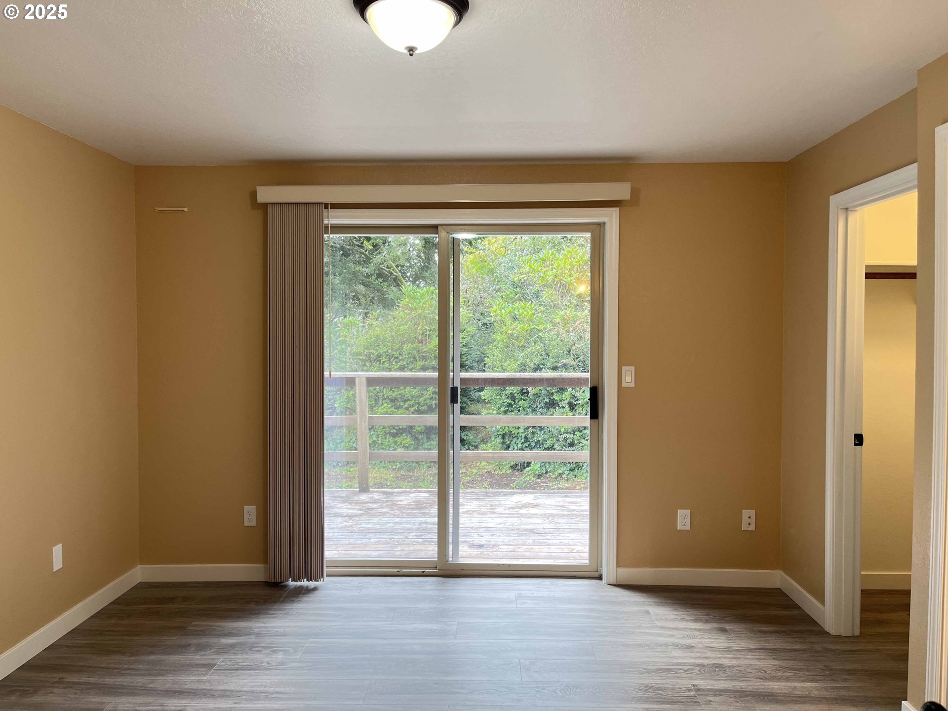 2040 11th Street Florence, OR 97439 - Photo 20 of 43 a view of an empty room with wooden floor and a window