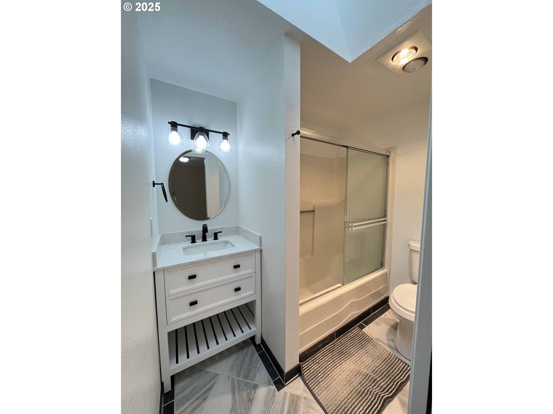 2040 11th Street Florence, OR 97439 - Photo 24 of 43 a bathroom with a mirror and a sink