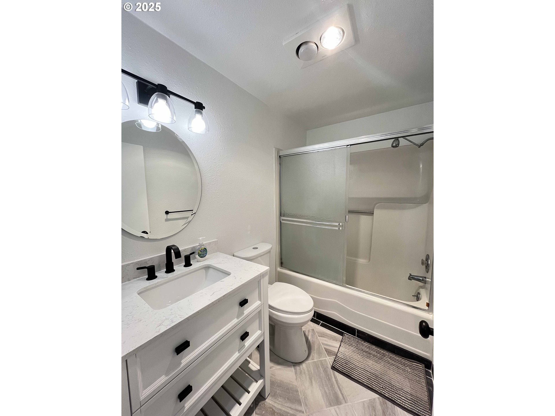 2040 11th Street Florence, OR 97439 - Photo 27 of 43 a bathroom with a sink mirror toilet and shower