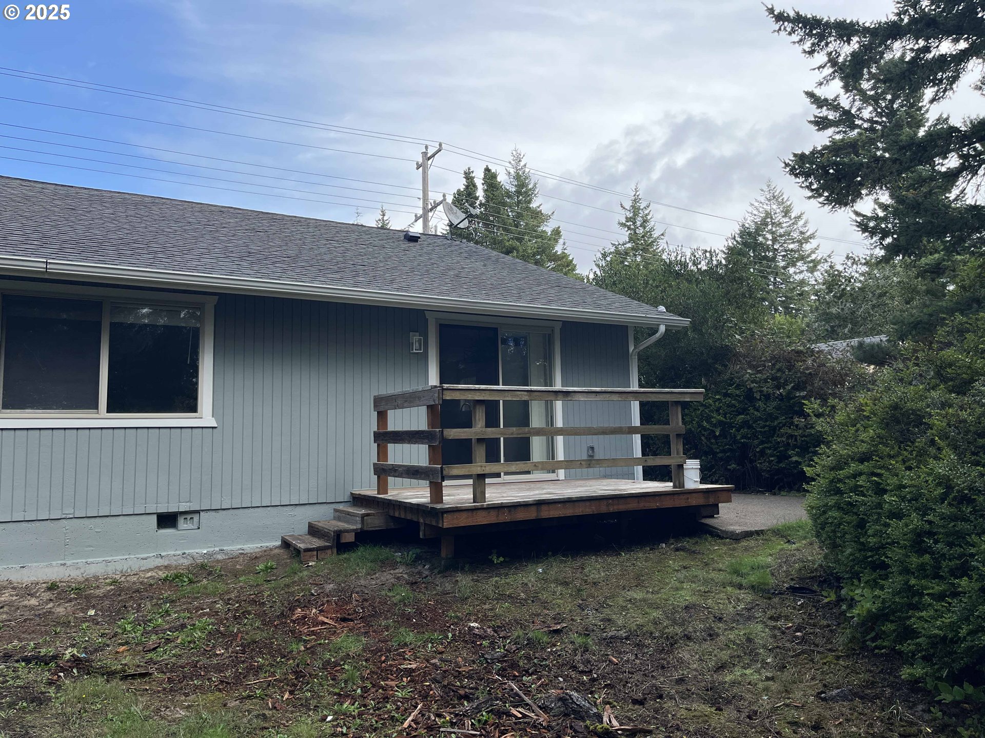 2040 11th Street Florence, OR 97439 - Photo 40 of 43 a view of a house with backyard and sitting area