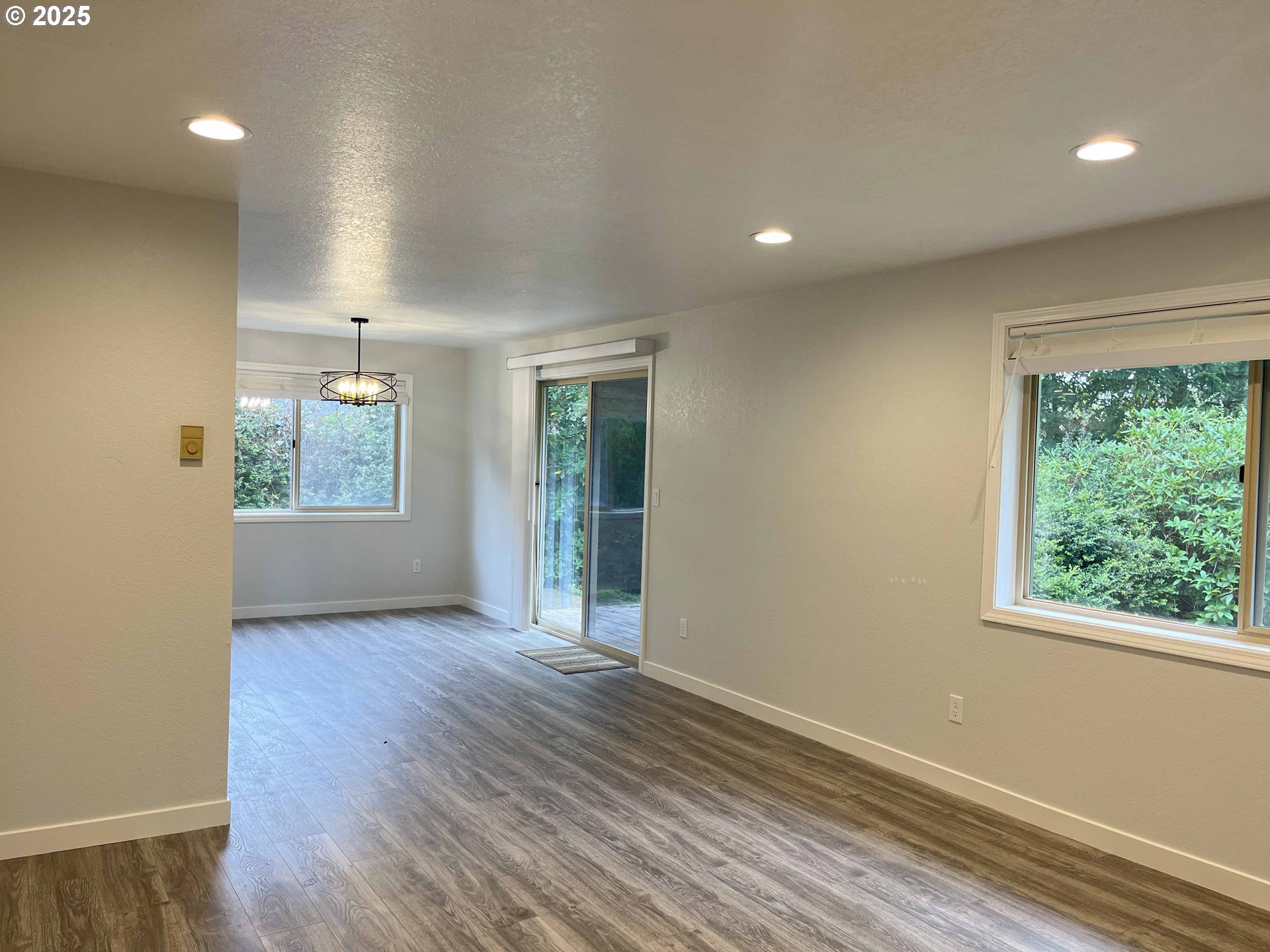 2040 11th Street Florence, OR 97439 - Photo 9 of 43 an empty room with wooden floor and windows