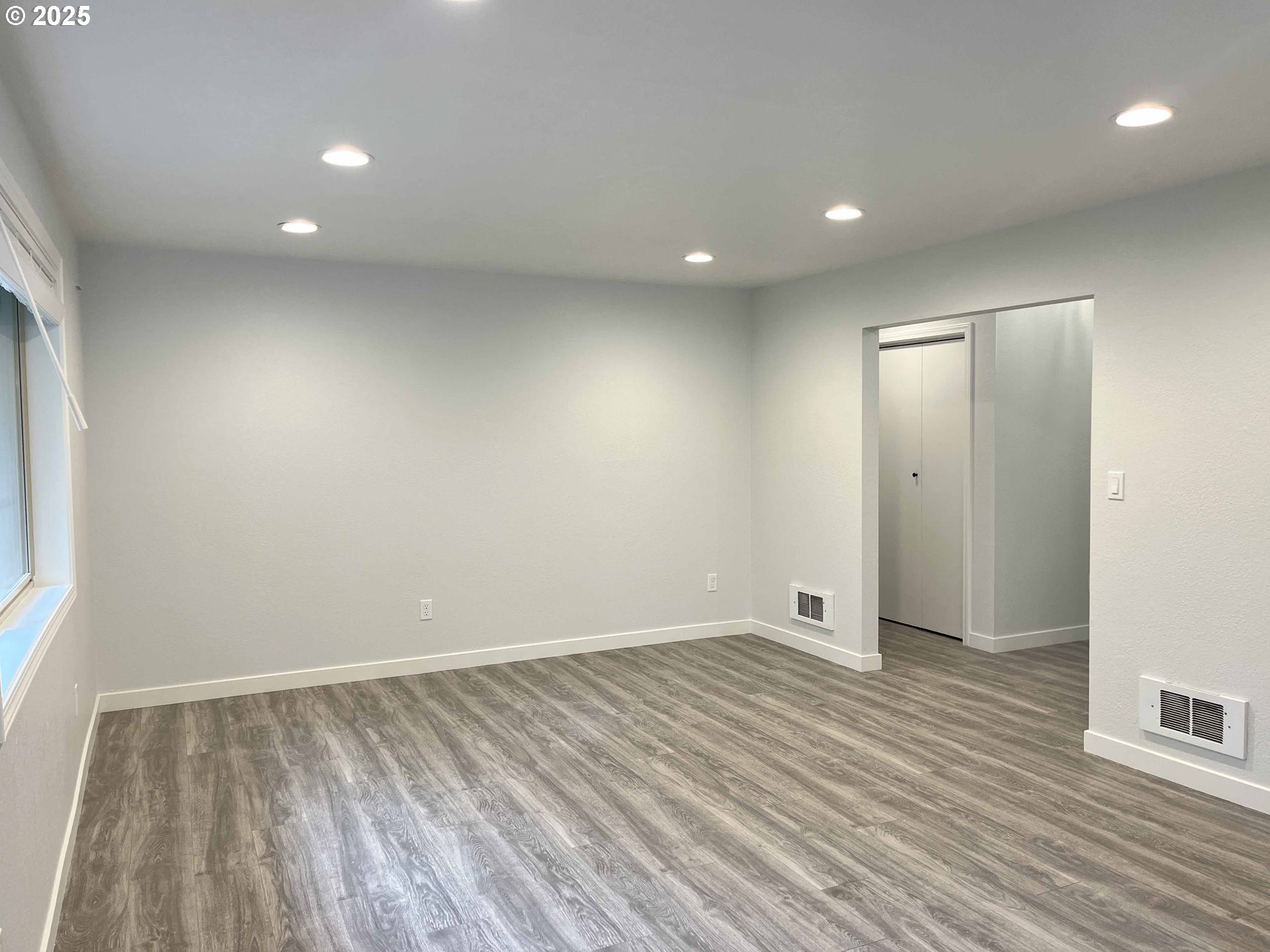 2040 11th Street Florence, OR 97439 - Photo 10 of 43 wooden floor in an empty room with a window