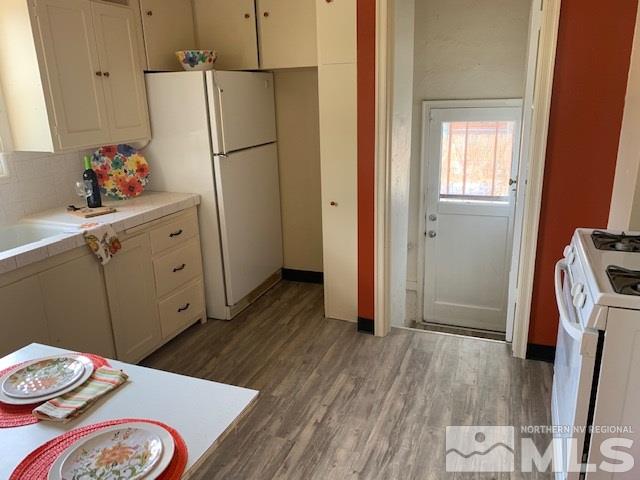 435 West Taylor Street Reno, NV 89509 - Photo 3 of 15 a kitchen with a refrigerator and wooden floor