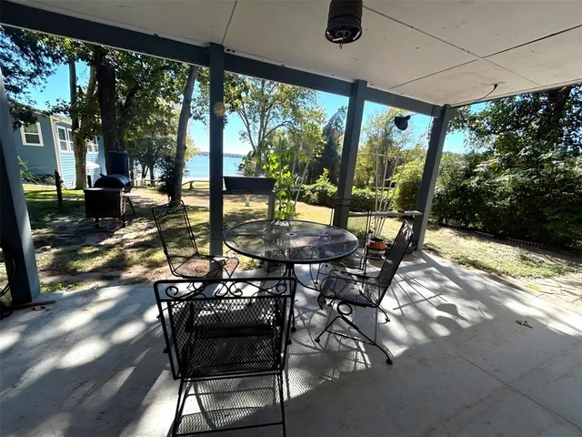 a patio with yard glass top table and chairs