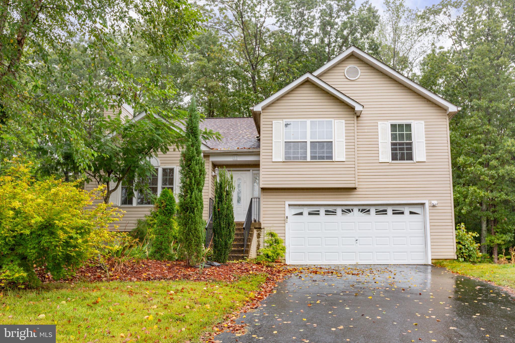 53 Bloomington Lane Stafford, VA 22554 - Photo 1 of 60 a view of a house with a yard and potted plants