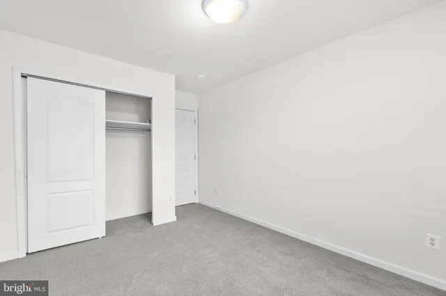 a bathroom with a sink a toilet a mirror and shower