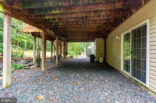 a front view of a house with a yard and potted plants
