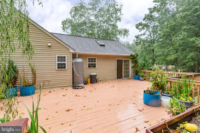 a view of a house with a yard and potted plants