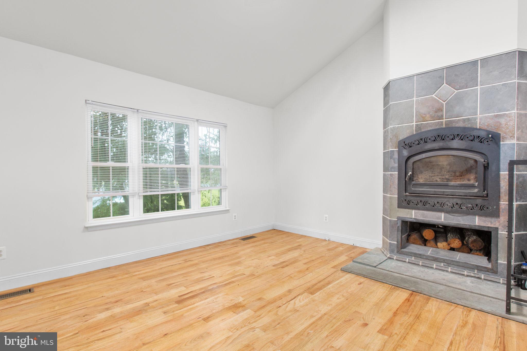 53 Bloomington Lane Stafford, VA 22554 - Photo 5 of 60 a view of an empty room with a fireplace and a window