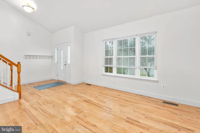 a view of an entryway with wooden floor
