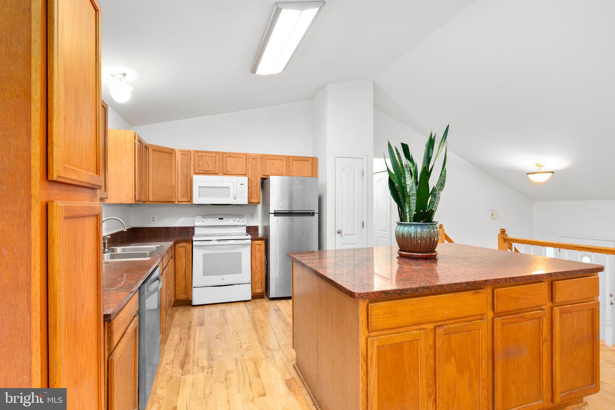 53 Bloomington Lane Stafford, VA 22554 - Photo 10 of 60 a kitchen with stainless steel appliances granite countertop sink stove and refrigerator