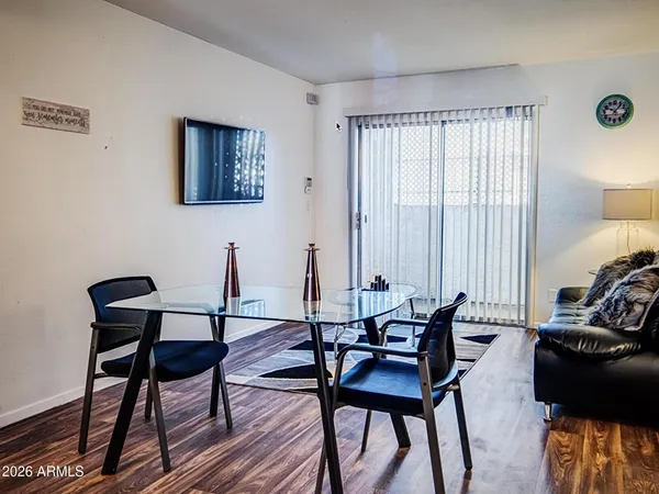 a bed sitting in a bedroom next to a window and a chandelier