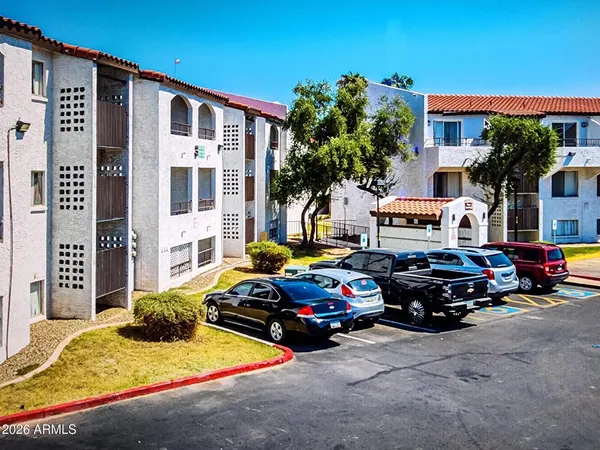 an aerial view of residential building with parking