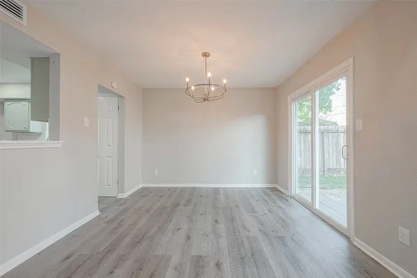 a kitchen with a sink a window a stove and white cabinets