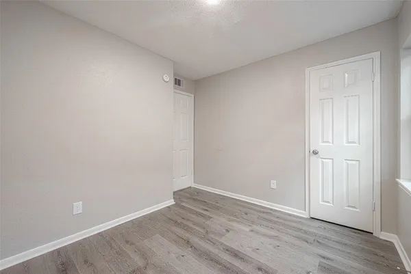 a view of a kitchen with white cabinets