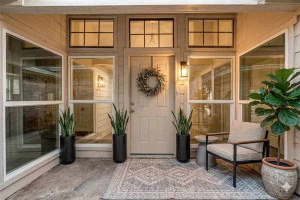 a view of a hallway with wooden floor and windows