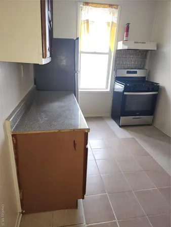 a kitchen with granite countertop a sink and a stove