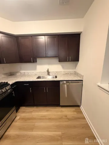 a kitchen with a sink and wooden cabinets