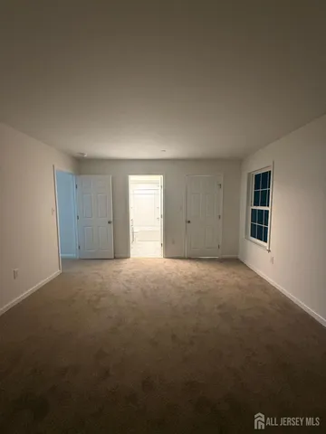 a view of an empty room and a window
