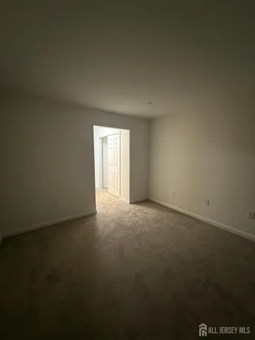 a view of an empty room and a window