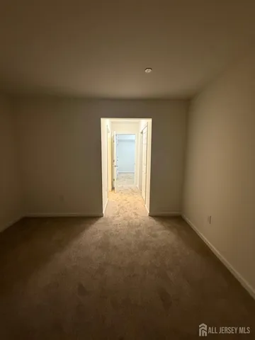 a view of an empty room and a window