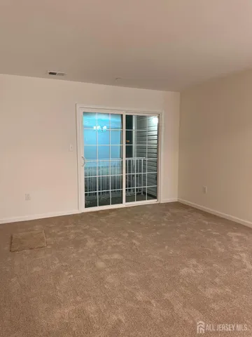 a view of an empty room with a large window