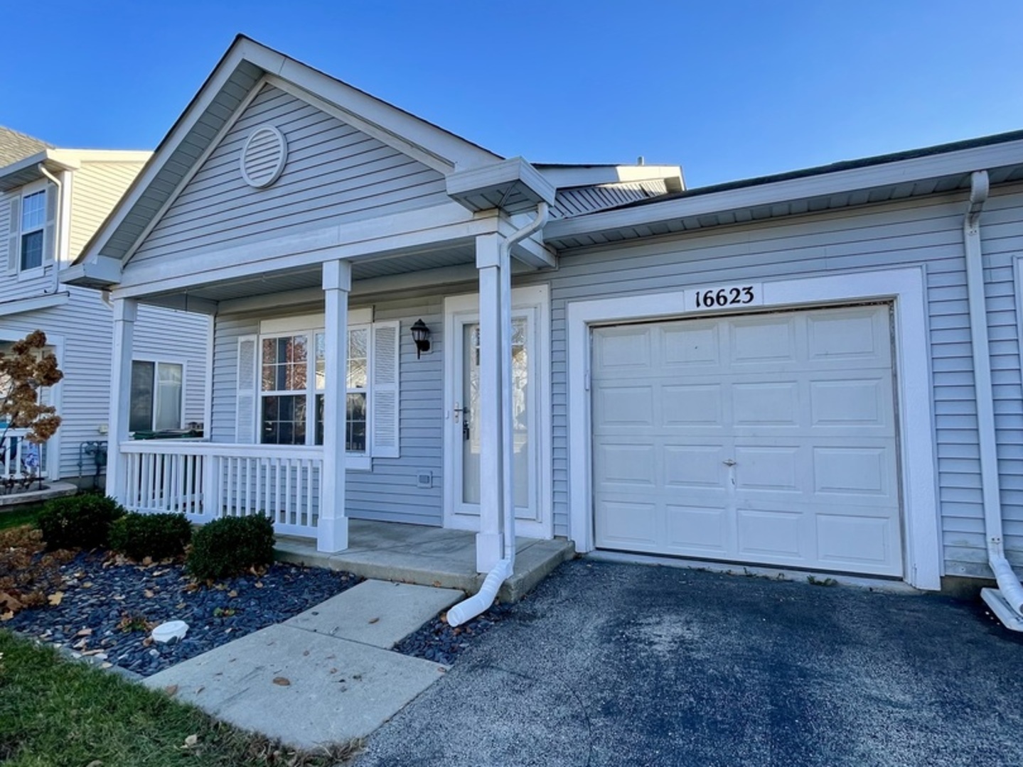 a view of a house with a small yard and wooden fence