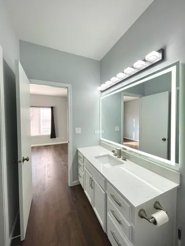a spacious bathroom with a double vanity sink and a mirror