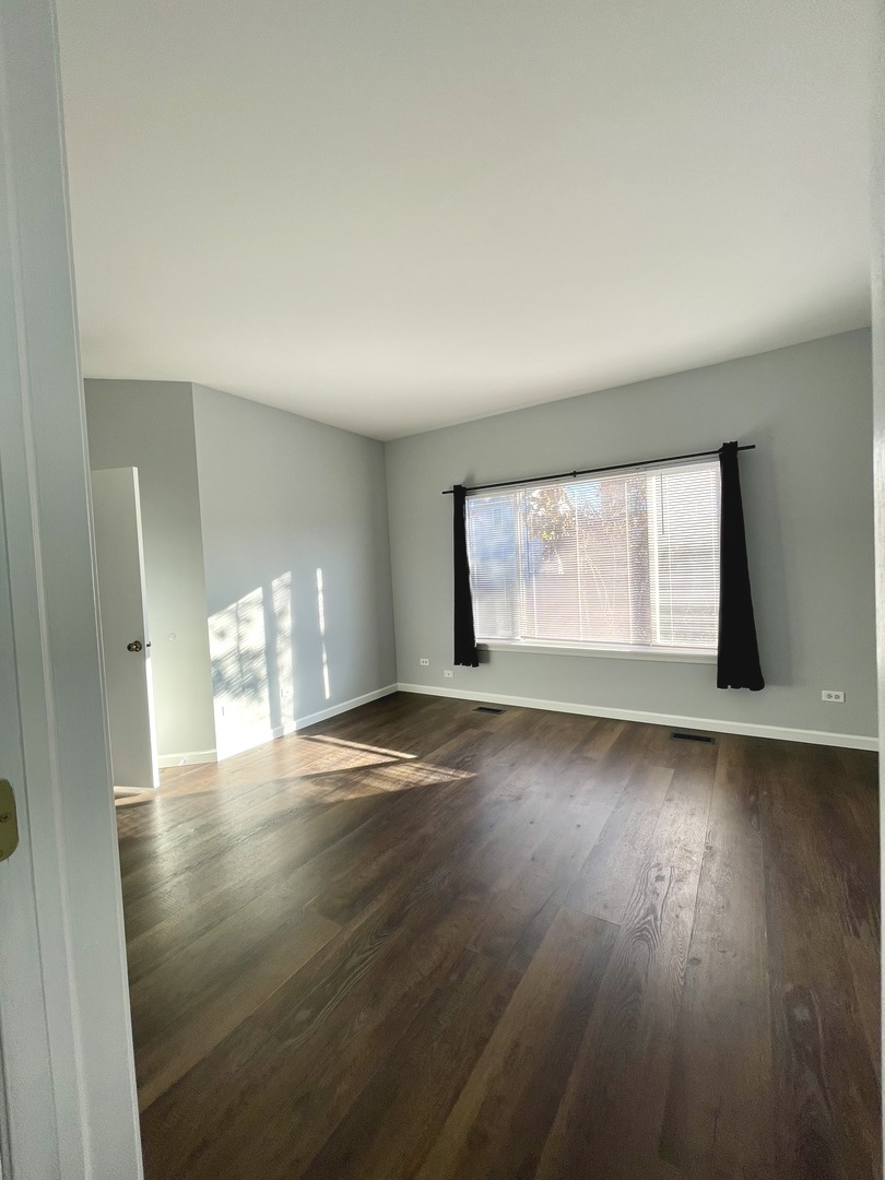 16623 Natoma Drive, Unit 16623 Lockport, IL 60441 - Photo 13 of 27 an empty room with wooden floor and windows