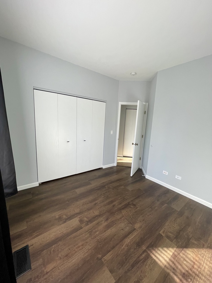 16623 Natoma Drive, Unit 16623 Lockport, IL 60441 - Photo 14 of 27 a view of an empty room with wooden floor and closet