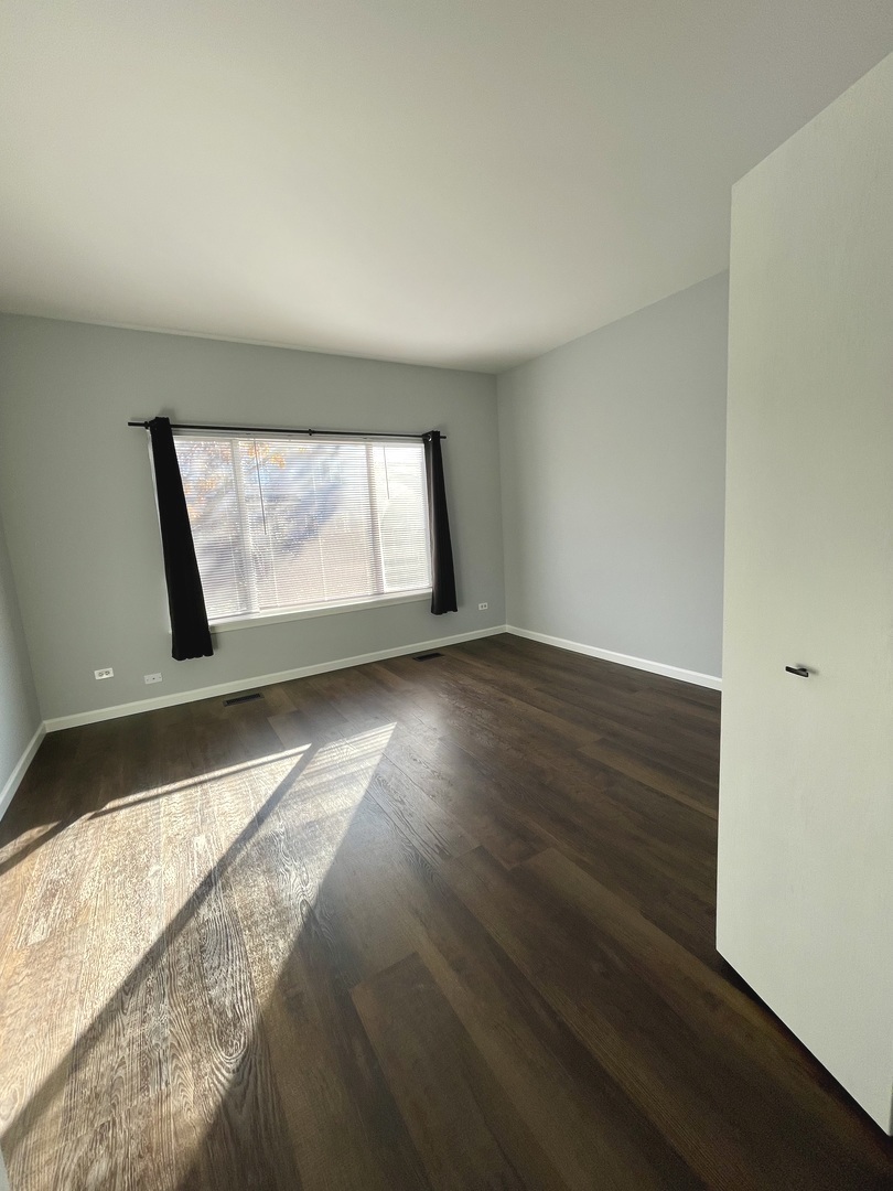 16623 Natoma Drive, Unit 16623 Lockport, IL 60441 - Photo 15 of 27 an empty room with wooden floor and windows