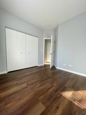 a view of an empty room and wooden floor