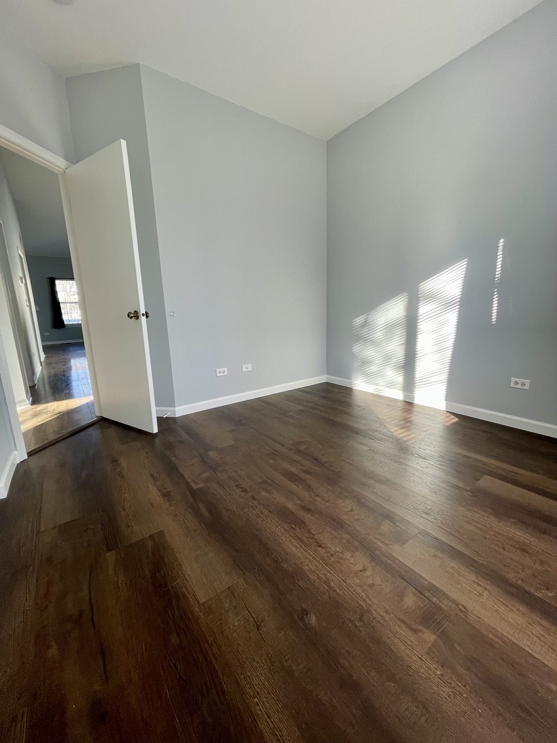 16623 Natoma Drive, Unit 16623 Lockport, IL 60441 - Photo 18 of 27 a view of an empty room with wooden floor and a window