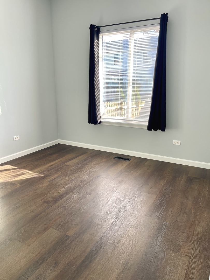 16623 Natoma Drive, Unit 16623 Lockport, IL 60441 - Photo 19 of 27 an empty room with wooden floor and windows