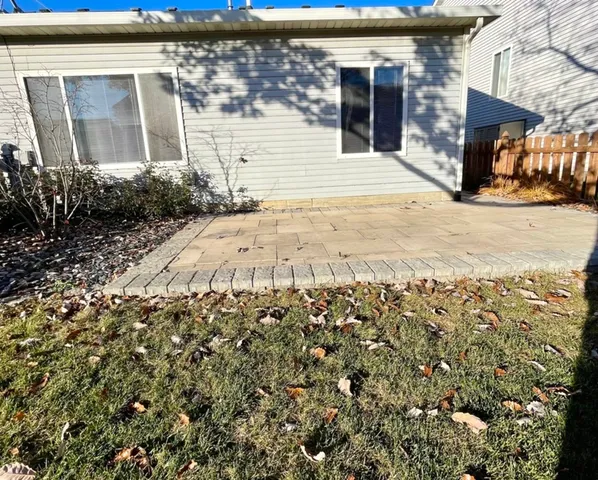 a view of a brick house with a large tree
