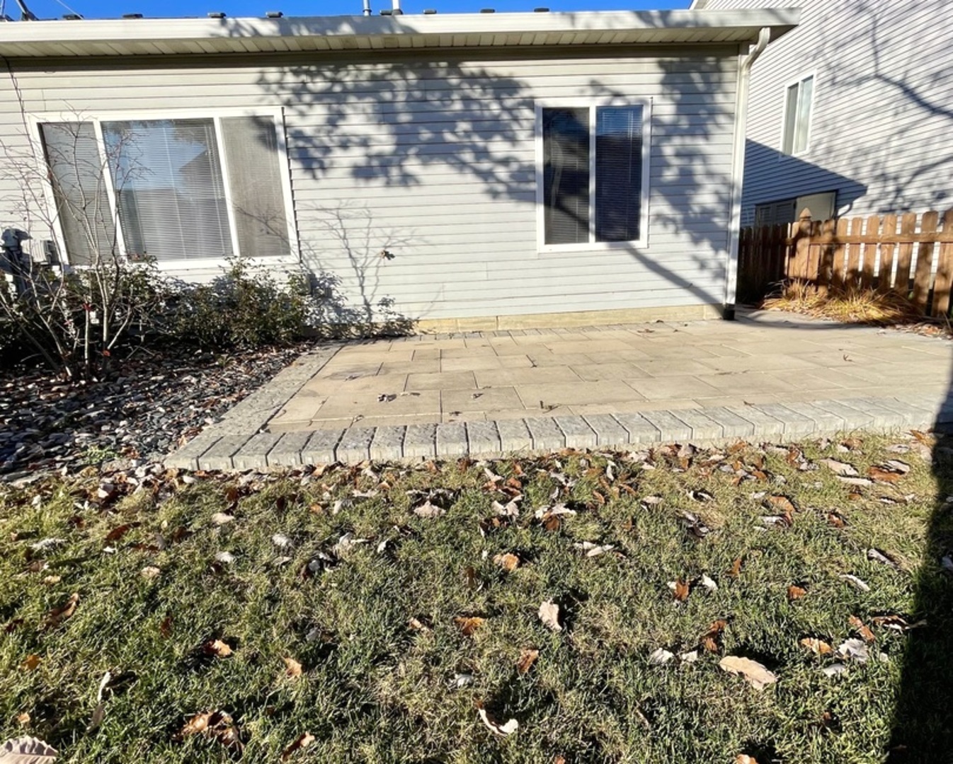 16623 Natoma Drive, Unit 16623 Lockport, IL 60441 - Photo 24 of 27 a view of a brick house with a large tree