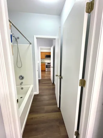 a bathroom with a bathtub a sink and a shower