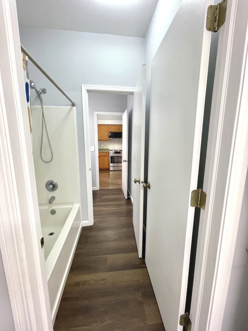 16623 Natoma Drive, Unit 16623 Lockport, IL 60441 - Photo 6 of 27 a bathroom with a bathtub a sink and a shower