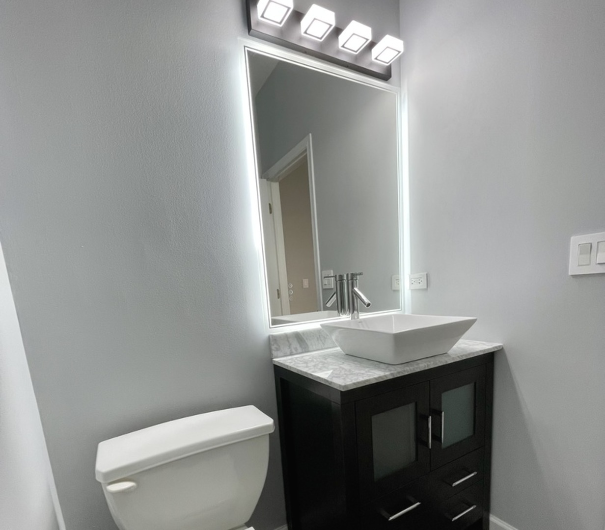 16623 Natoma Drive, Unit 16623 Lockport, IL 60441 - Photo 8 of 27 a bathroom with a sink a toilet and mirror