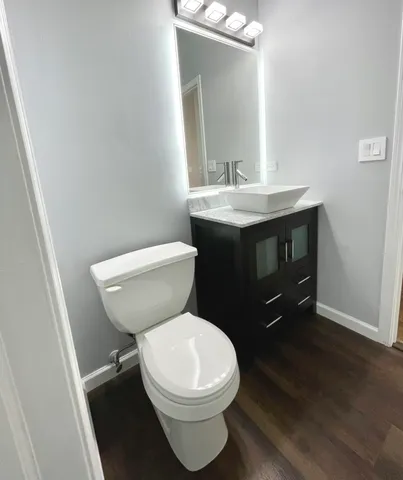 a bathroom with a toilet a sink and mirror
