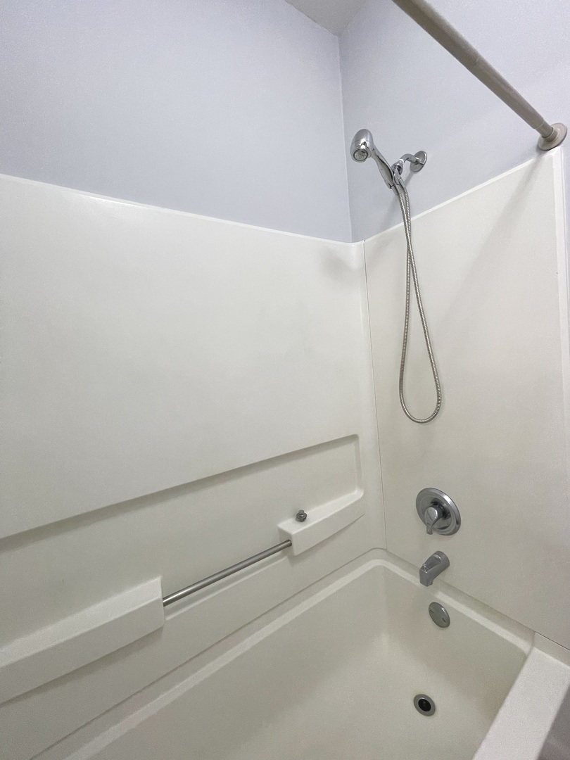 16623 Natoma Drive, Unit 16623 Lockport, IL 60441 - Photo 10 of 27 a bathroom with a bath tub with a shower
