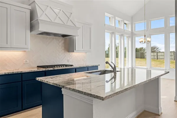 a kitchen with granite countertop a sink and a cabinets