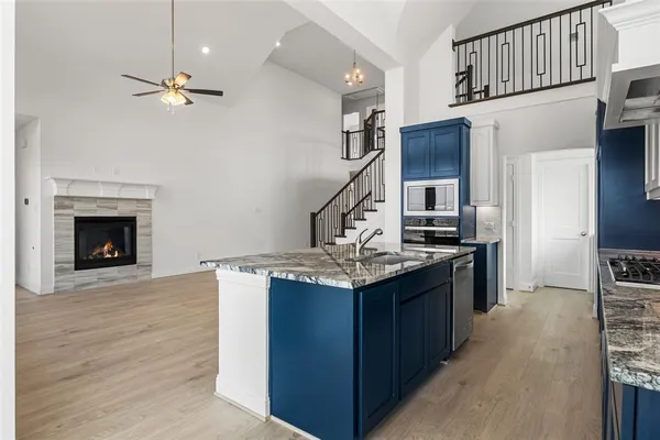 a kitchen with stainless steel appliances granite countertop a stove and a refrigerator