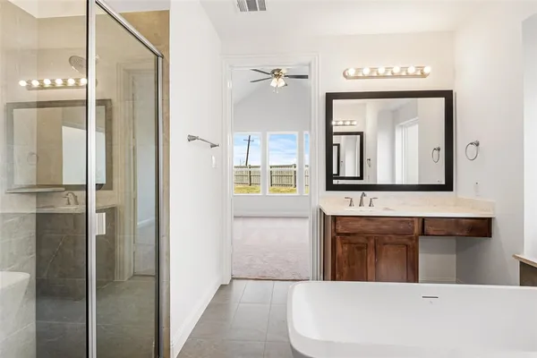 a bathroom with a bathtub and a mirror