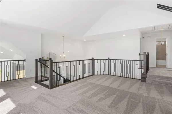 a view of staircase with railing and a window