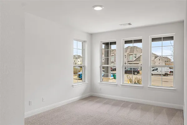 an empty room with windows and closet