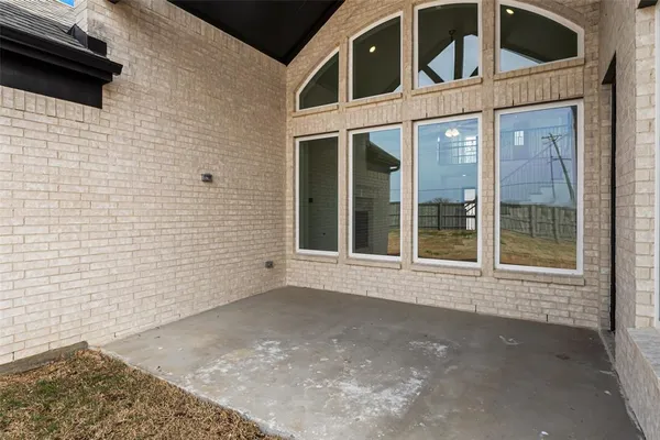 a view of a brick house with a large window