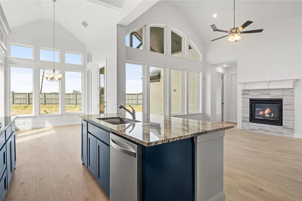 a kitchen with stainless steel appliances granite countertop a sink and a wooden floors