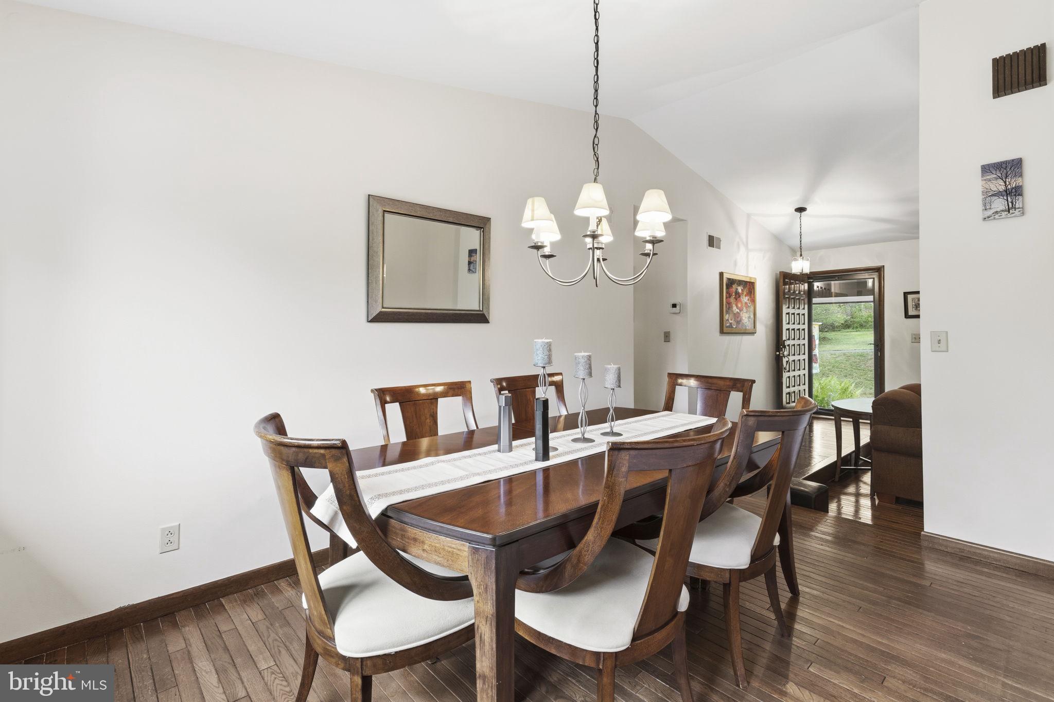 2009 Wilson Road White Hall, MD 21161 - Photo 20 of 68 a view of a dining room with furniture a chandelier and wooden floor